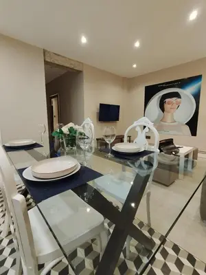 a dining room with a glass table and white chairs at Mamá Ignacia in Lugo