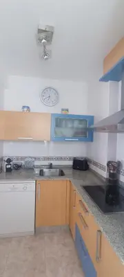 a kitchen with a sink and a clock on the wall at La Atalaya de Sanci in San Ciprián
