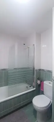 a bathroom with a shower and a toilet and a tub at La Atalaya de Sanci in San Ciprián