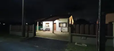a small house at night with the lights on at Casa da Braña in Teo