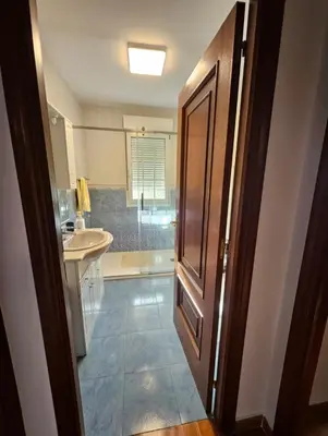 a bathroom with a sink and a shower and a door at Casa Pepe in Ourense