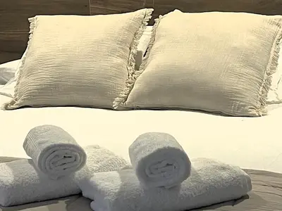 a bed with white towels and pillows on it at O Luar in Piñeira Seca