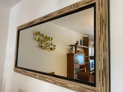 a mirror with a bunch of gold balloons on a wall at Alojamiento Camiña in Caldas de Reis