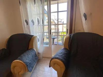 two couches in a living room with a window at Alojamiento Camiña in Caldas de Reis
