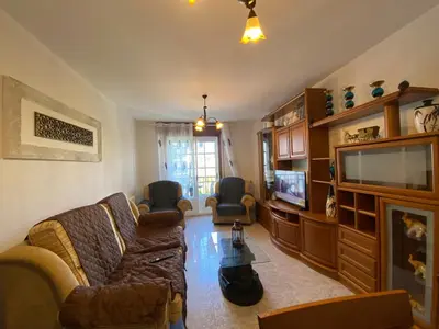 a living room with a couch and a tv at Alojamiento Camiña in Caldas de Reis