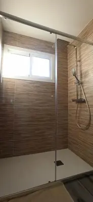 a shower with a glass door in a bathroom at Eido do Avelán in Mondariz