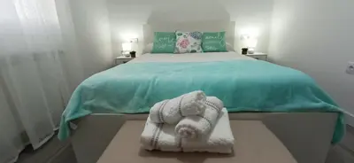 a bedroom with a bed with towels on it at Eido do Avelán in Mondariz