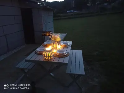 a picnic table with plates and lights on it at Eido do Avelán in Mondariz