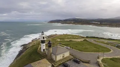 an aerial view of a lighthouse on the ocean at EnSAN CIPRIAN Playas y Gastronomía in San Ciprián