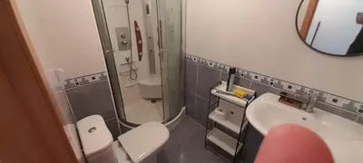 a bathroom with a toilet and a sink and a mirror at EnSAN CIPRIAN Playas y Gastronomía in San Ciprián