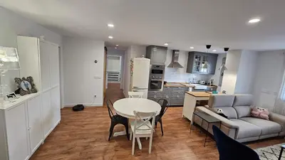 a kitchen and living room with a table and a couch at Costa verde asturiana - VUT4692AS in El Espín