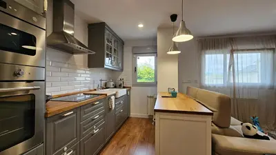 a kitchen with stainless steel appliances and a wooden counter top at Costa verde asturiana - VUT4692AS in El Espín