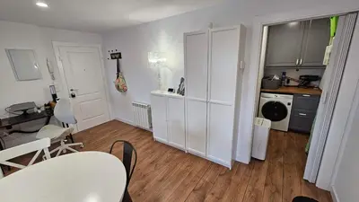a kitchen with white cabinets and a table and chairs at Costa verde asturiana - VUT4692AS in El Espín