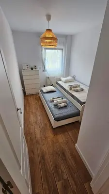 a bedroom with two beds and a chandelier at Costa verde asturiana - VUT4692AS in El Espín