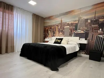 a bedroom with a large bed with a painting on the wall at Dream House II -Termas cerca -parking gratis- in Ourense