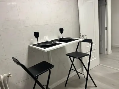 a table with two chairs and two wine glasses on it at Dream House II -Termas cerca -parking gratis- in Ourense