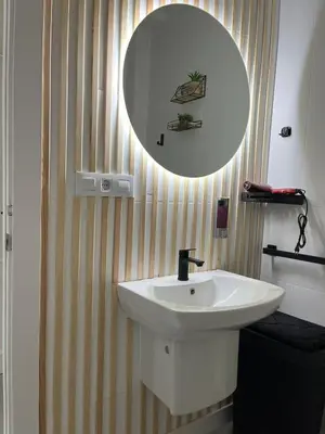 a bathroom with a white sink and a mirror at Dream House II -Termas cerca -parking gratis- in Ourense