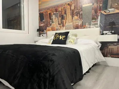 a black and white bed in a bedroom with a city at Dream House II -Termas cerca -parking gratis- in Ourense