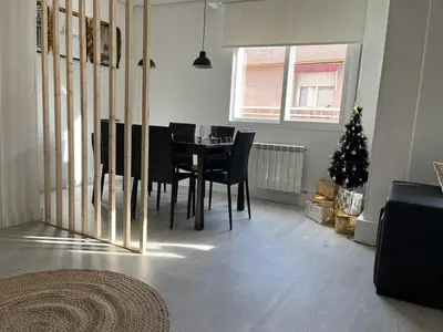 a dining room with a table and a christmas tree at Dream House II -Termas cerca -parking gratis- in Ourense