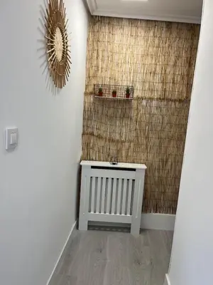 a bathroom with a radiator and a mirror on the wall at Dream House II -Termas cerca -parking gratis- in Ourense