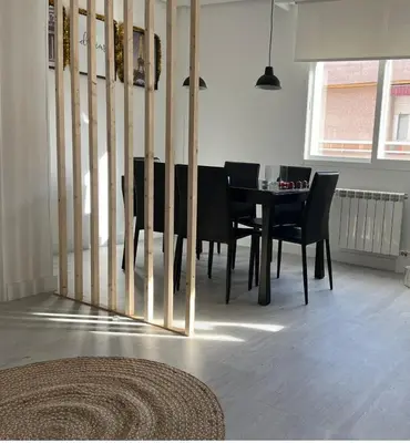 a dining room with a black table and chairs at Dream House II -Termas cerca -parking gratis- in Ourense