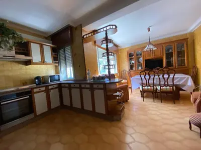 a kitchen and dining room with a table in the background at Royal Street Refuge in Caldas de Reis