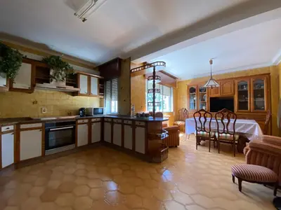 a kitchen with a table and a dining room at Royal Street Refuge in Caldas de Reis