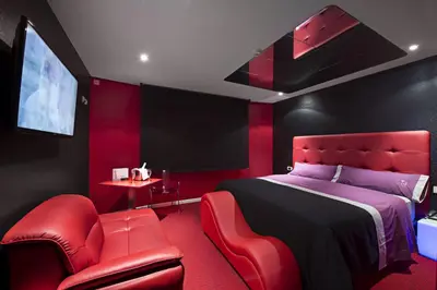 a red bedroom with a bed and red chairs at Motel Venus La Coruña in Guísamo