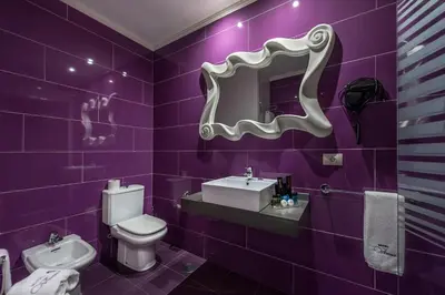 a purple bathroom with a sink and a toilet at Motel Venus La Coruña in Guísamo