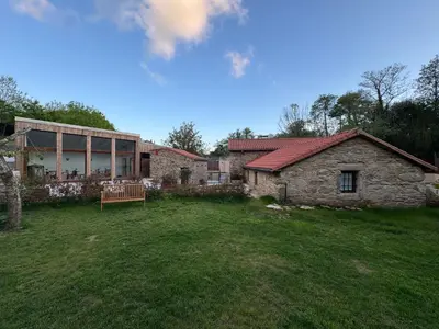 a house with a large yard in front of it at Luar do Sarela Rooms in Santiago de Compostela