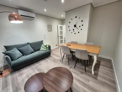 a living room with a couch and a table at Máximo Meridio in Ourense