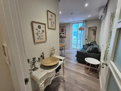 a living room with a table and a couch at Máximo Meridio in Ourense