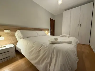 a bedroom with a white bed with towels on it at Santa María in Lugo