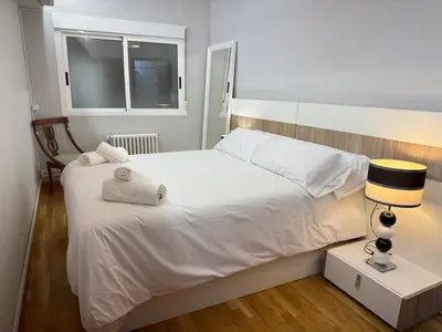 a bedroom with a white bed and a window at Santa María in Lugo