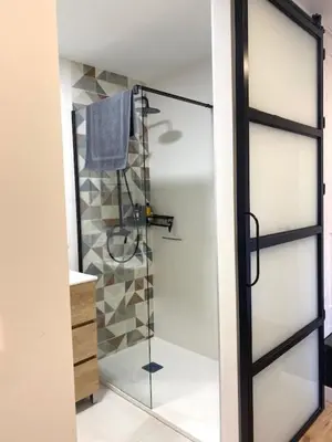 a bathroom with a shower with a glass door at Mirador de la Montaña Mágica in El Acebo de San Miguel