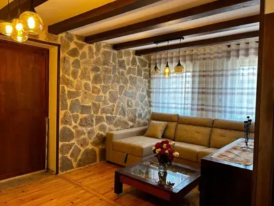 a living room with a couch and a table at El tejo milenario in Requejo