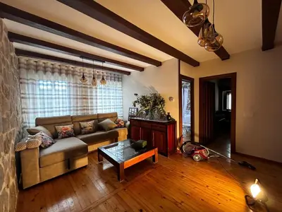 a living room with a couch and a table at El tejo milenario in Requejo