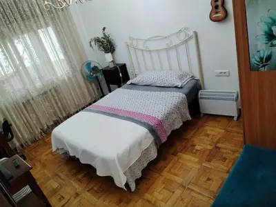 a bedroom with a bed with a white headboard at Casa albergue Pty in Sarria