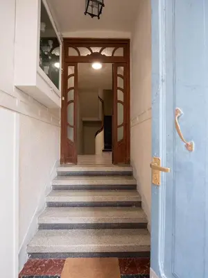 a hallway with stairs with a blue door at La Fantástica Pontedeume 1 in Puentedeume