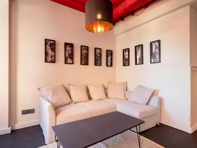 a living room with a couch and pictures on the wall at La Fantástica Pontedeume 1 in Puentedeume