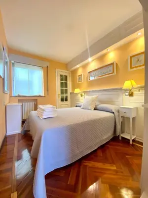 a bedroom with a large bed with white sheets at Loft Lugo Centro in Lugo