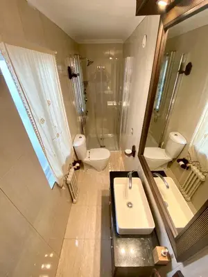 a bathroom with two toilets and a sink and a shower at Loft Lugo Centro in Lugo