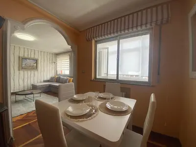 a dining room with a white table and a window at Loft Lugo Centro in Lugo