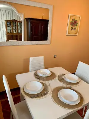 a dining room table with white plates on it at Loft Lugo Centro in Lugo