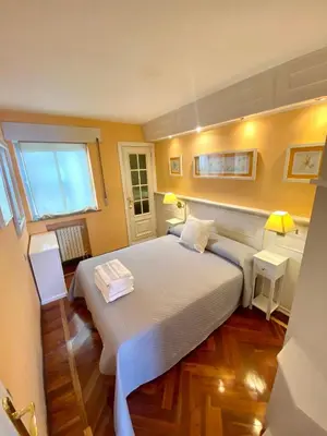 a bedroom with a large bed and a desk at Loft Lugo Centro in Lugo