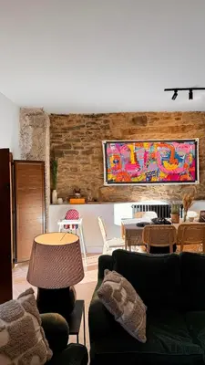 a living room with couches and tables and a painting at Casa boutique-rural en El Bierzo in Torre del Bierzo