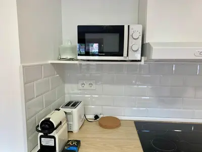 a kitchen with a microwave on top of a counter at Apartamento con vistas al río in Betanzos
