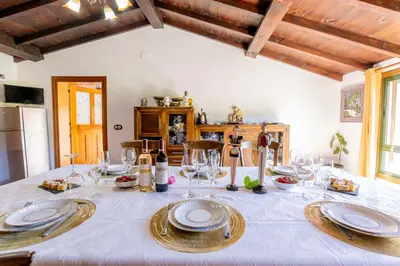 a dining room table with plates and glasses on it at Lagar de Beuvas in Camanzo