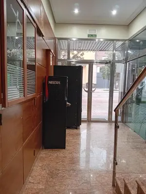 an empty hallway with a news machine in a building at El Ancla in Ponferrada