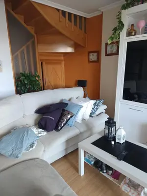 a living room with a white couch and a table at Foz te espera in Foz